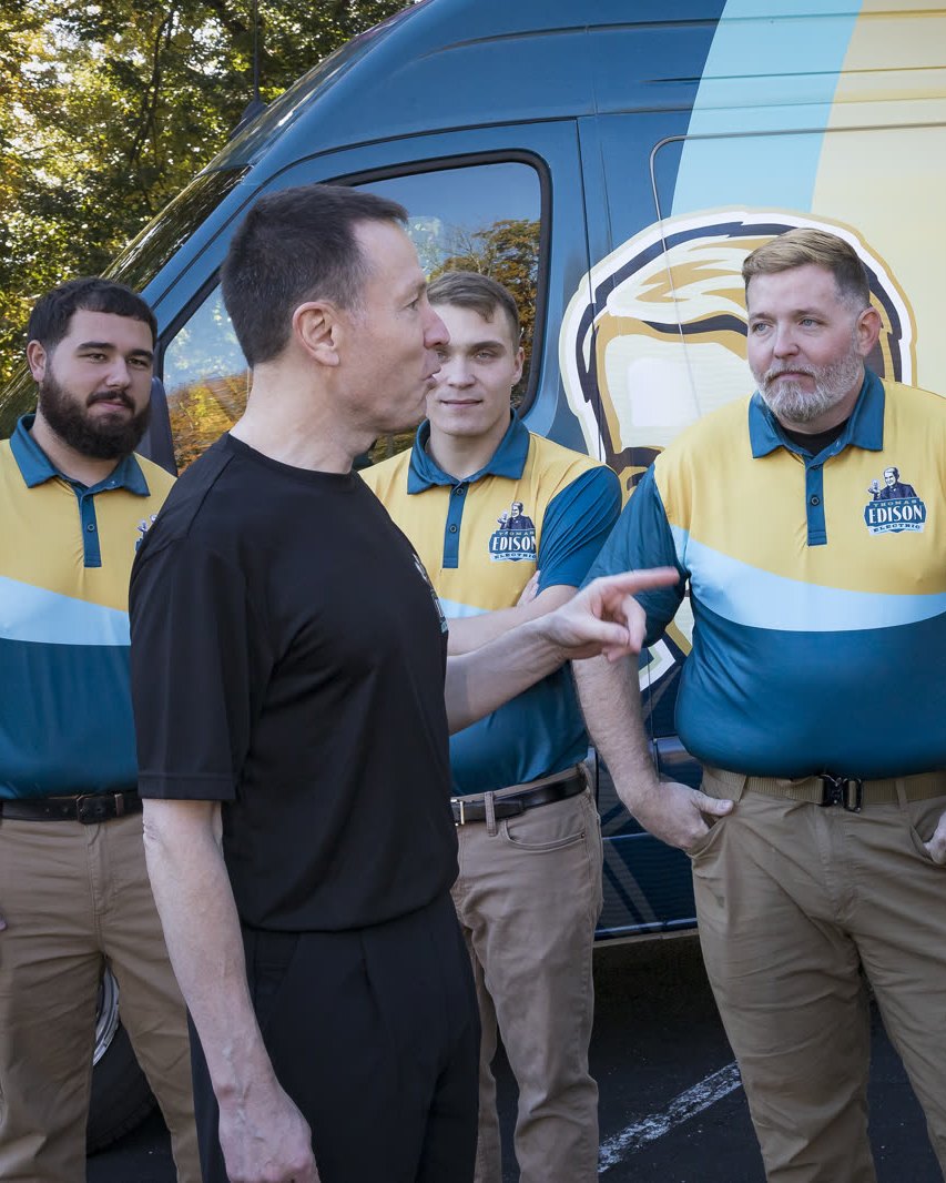 Joe White, Founder and Master Electrician, briefing the team